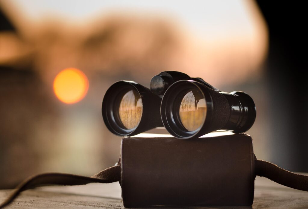photo of binoculars sitting on top of a bag