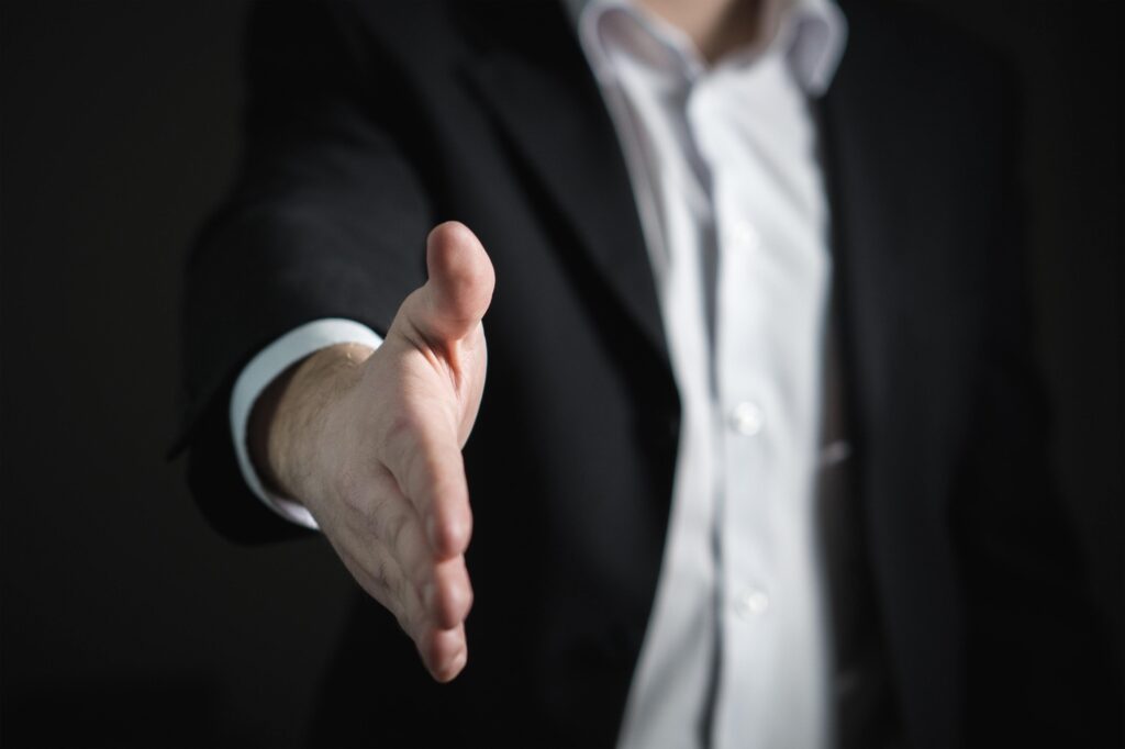 person reaching their hand out for a handshake